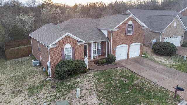 214 Cobblestone Lndg, Mount Juliet, TN 37122 - traditional home featuring brick siding, driveway, an attached garage, central AC unit, and a shingled roof