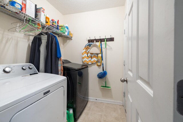 214 Cobblestone Lndg, Mount Juliet, TN 37122 - washroom featuring washer and clothes dryer, baseboards, and a textured ceiling