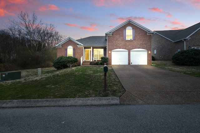 214 Cobblestone Lndg, Mount Juliet, TN 37122 - traditional-style house with brick siding, concrete driveway, a garage, and a lawn