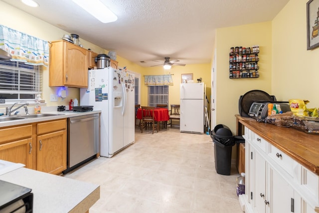 214 Cobblestone Lndg, Mount Juliet, TN 37122 - kitchen featuring freestanding refrigerator, dishwasher, ceiling fan, white refrigerator with ice dispenser, and a sink