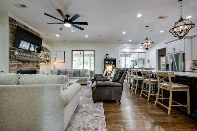 1092 Meeks Cemetery Rd, Burns, TN 37029 - living area with a chandelier, ceiling fan, recessed lighting, crown molding, and dark wood-type flooring