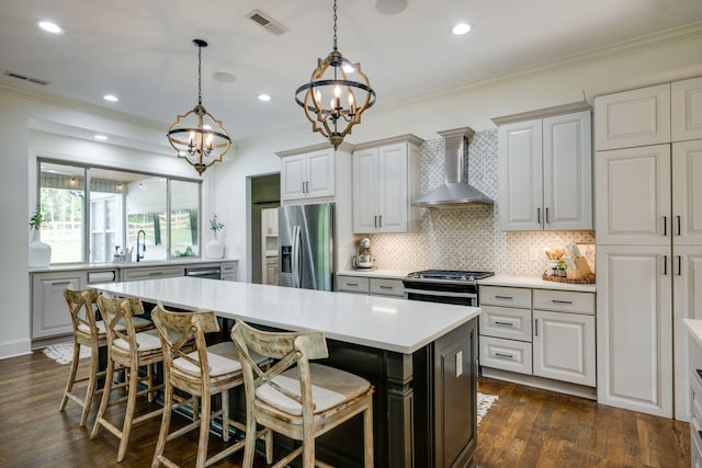 1092 Meeks Cemetery Rd, Burns, TN 37029 - kitchen with wall chimney range hood, stainless steel appliances, a chandelier, light countertops, and crown molding