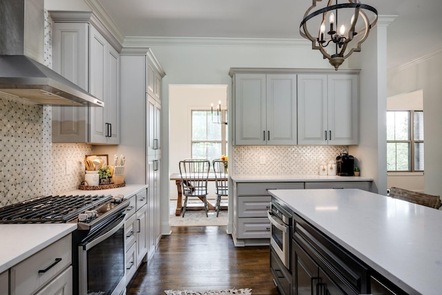 1092 Meeks Cemetery Rd, Burns, TN 37029 - kitchen with wall chimney range hood, stainless steel appliances, a chandelier, plenty of natural light, and ornamental molding