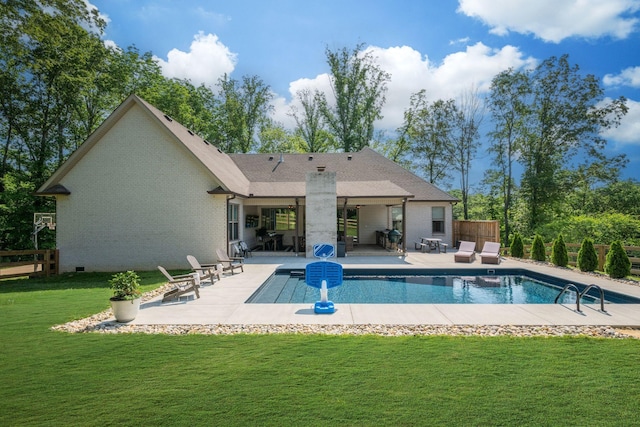1092 Meeks Cemetery Rd, Burns, TN 37029 - back of house featuring a patio, a yard, an outdoor pool, brick siding, and a chimney