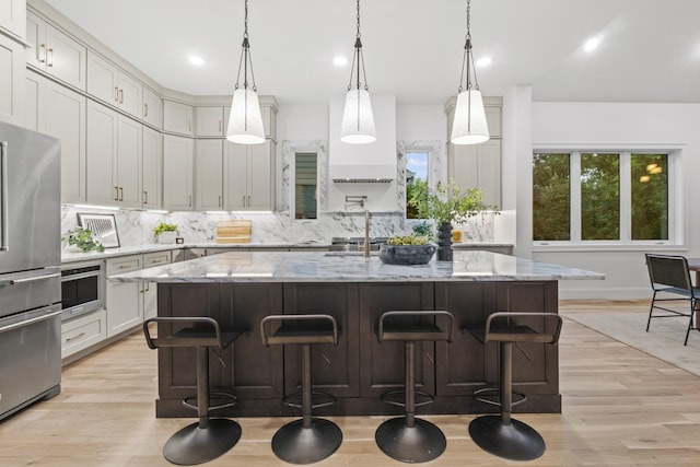 1438 Janie Ave, Nashville, TN 37216 - kitchen featuring stainless steel appliances, tasteful backsplash, light wood finished floors, light stone counters, and recessed lighting