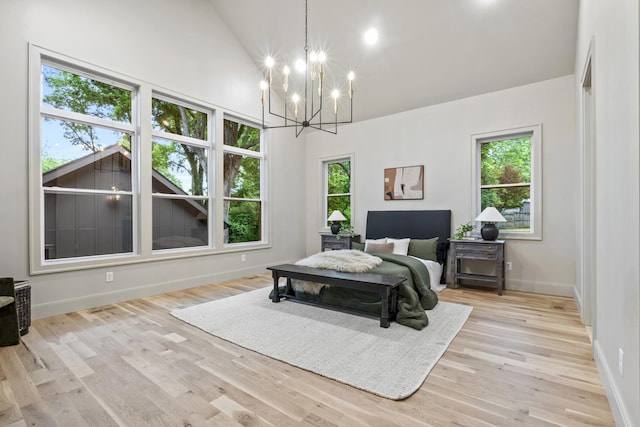 1438 Janie Ave, Nashville, TN 37216 - bedroom with multiple windows, baseboards, a chandelier, light wood finished floors, and high vaulted ceiling