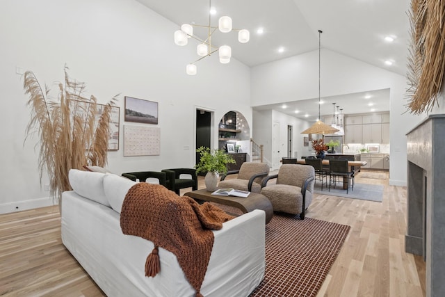 1438 Janie Ave, Nashville, TN 37216 - living room with high vaulted ceiling, stairs, light wood-style floors, a chandelier, and recessed lighting