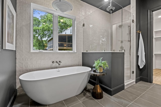 1438 Janie Ave, Nashville, TN 37216 - bathroom featuring a shower stall, a soaking tub, tile walls, and tile patterned floors