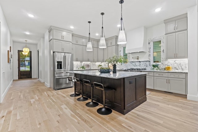 1438 Janie Ave, Nashville, TN 37216 - kitchen with high end fridge, custom exhaust hood, decorative backsplash, a center island, and recessed lighting