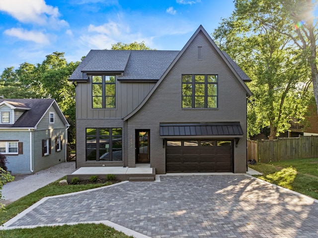 1438 Janie Ave, Nashville, TN 37216 - view of front facade with board and batten siding, a garage, decorative driveway, and brick siding