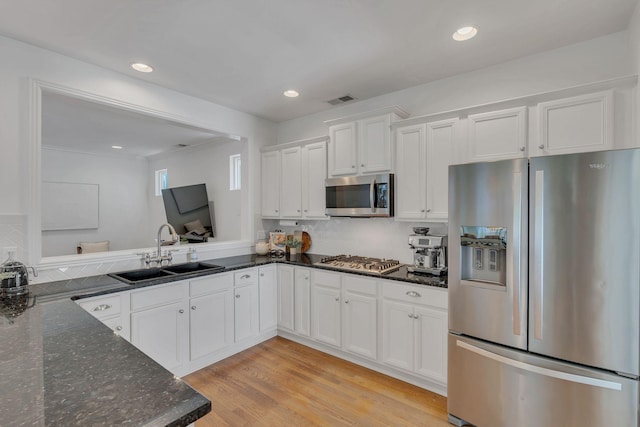 118 Jasper Ave, Franklin, TN 37064 - kitchen with stainless steel appliances, a sink, dark stone countertops, white cabinetry, and tasteful backsplash
