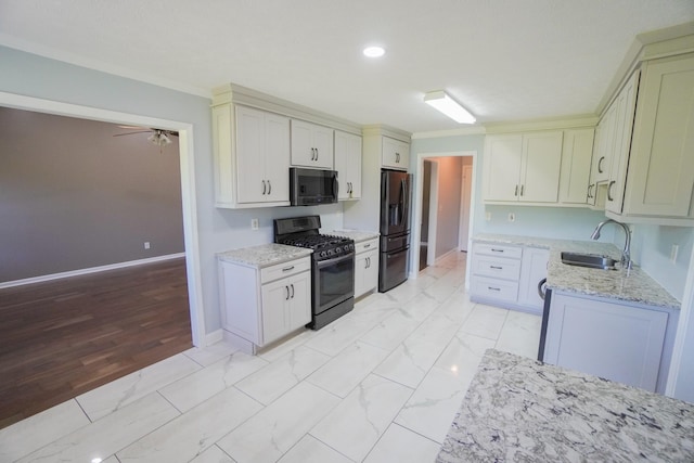 1009 Monticello Pl, Gallatin, TN 37066 - kitchen featuring stainless steel appliances, a sink, light stone countertops, baseboards, and light marble finish flooring