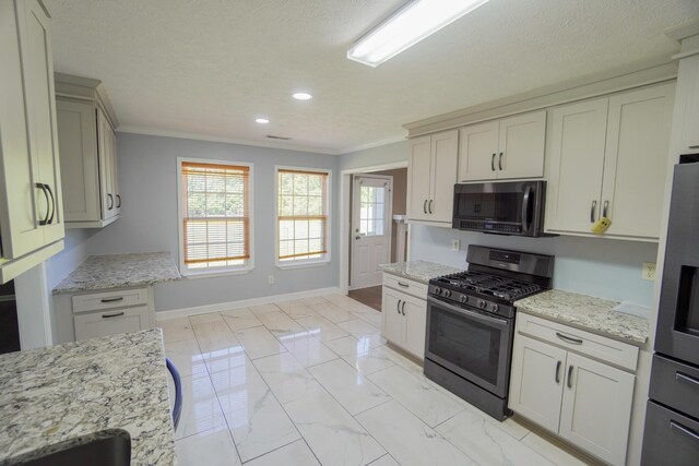 1009 Monticello Pl, Gallatin, TN 37066 - kitchen with appliances with stainless steel finishes, light marble finish flooring, crown molding, recessed lighting, and light stone counters