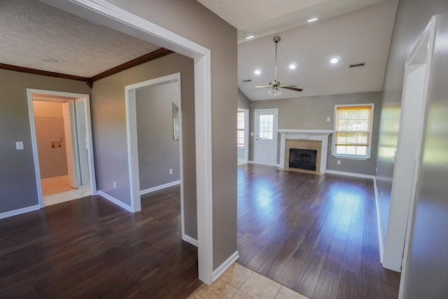1009 Monticello Pl, Gallatin, TN 37066 - unfurnished living room with ceiling fan, baseboards, lofted ceiling, a fireplace, and wood finished floors