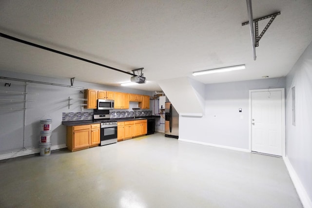 1009 Monticello Pl, Gallatin, TN 37066 - garage featuring baseboards, a garage door opener, stainless steel fridge, and a sink