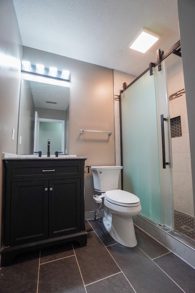 1009 Monticello Pl, Gallatin, TN 37066 - bathroom featuring a stall shower, tile patterned flooring, vanity, toilet, and a textured ceiling