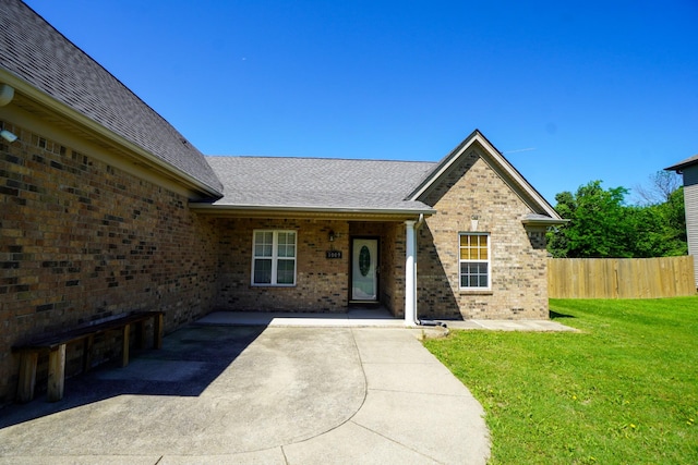 1009 Monticello Pl, Gallatin, TN 37066 - doorway to property featuring brick siding, a shingled roof, and a patio