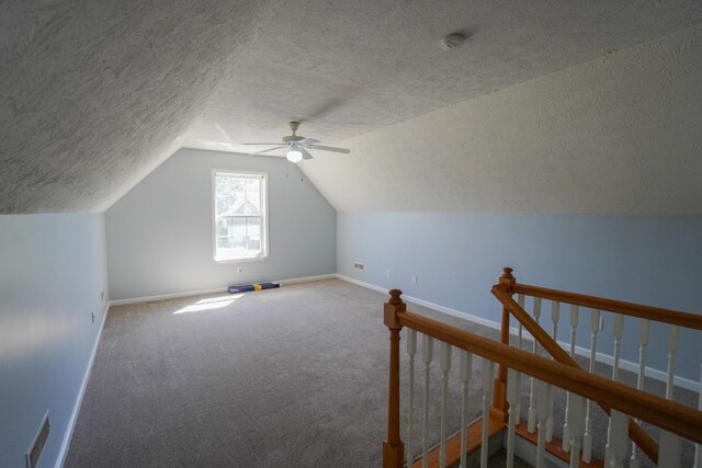 1009 Monticello Pl, Gallatin, TN 37066 - additional living space featuring baseboards, a textured ceiling, a ceiling fan, vaulted ceiling, and carpet floors