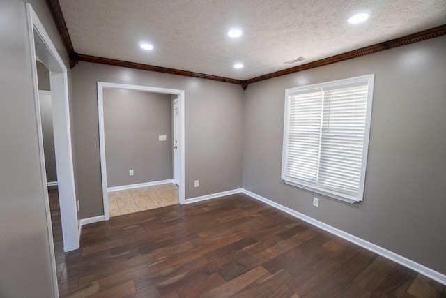 1009 Monticello Pl, Gallatin, TN 37066 - empty room with crown molding, a textured ceiling, dark wood-style flooring, recessed lighting, and baseboards
