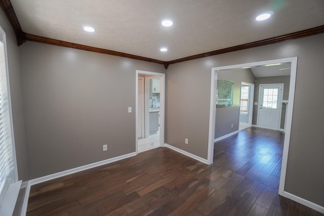 1009 Monticello Pl, Gallatin, TN 37066 - unfurnished room featuring dark wood-type flooring, ornamental molding, baseboards, recessed lighting, and a sink