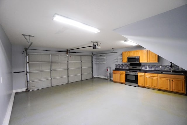 1009 Monticello Pl, Gallatin, TN 37066 - garage featuring a sink, a garage door opener, and baseboards