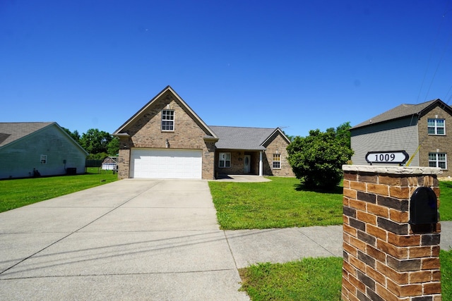 1009 Monticello Pl, Gallatin, TN 37066 - traditional-style home with a front yard, a garage, brick siding, and driveway