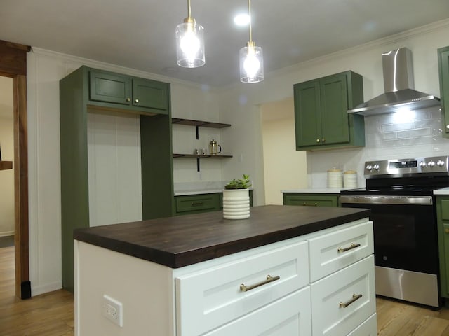 205 W 5th St, Parsons, TN 38363 - kitchen with wall chimney range hood, stainless steel electric range oven, green cabinets, light wood-style floors, and ornamental molding