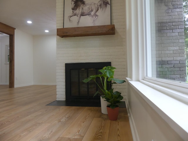 205 W 5th St, Parsons, TN 38363 - detailed view of wood finished floors, a brick fireplace, recessed lighting, and baseboards