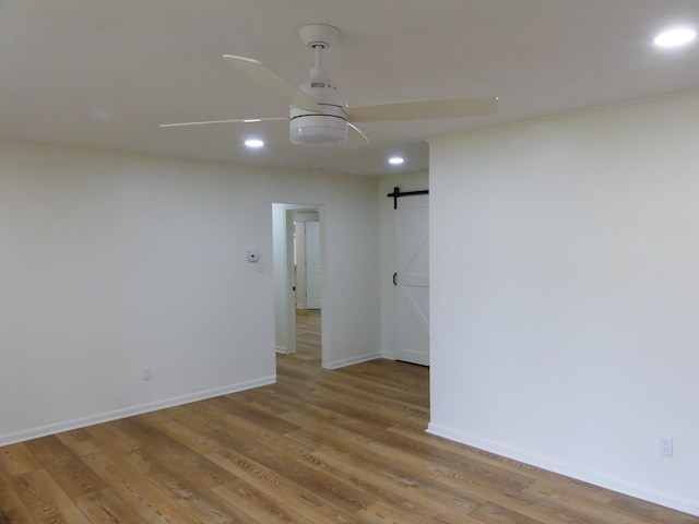 205 W 5th St, Parsons, TN 38363 - empty room with recessed lighting, a barn door, light wood finished floors, baseboards, and a ceiling fan