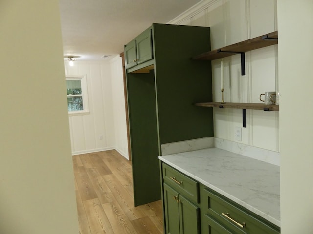 205 W 5th St, Parsons, TN 38363 - kitchen with green cabinetry, light wood-type flooring, open shelves, and light stone countertops