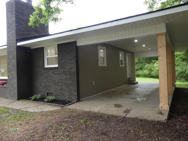 205 W 5th St, Parsons, TN 38363 - view of side of property with a chimney and brick siding