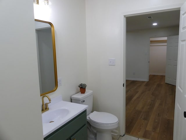 205 W 5th St, Parsons, TN 38363 - bathroom with vanity, wood finished floors, and toilet
