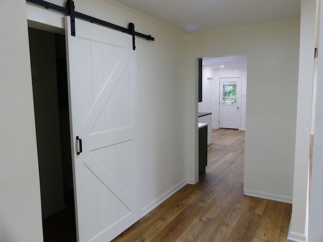 205 W 5th St, Parsons, TN 38363 - hall with a barn door, wood-type flooring, and baseboards