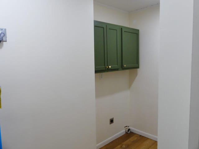 205 W 5th St, Parsons, TN 38363 - washroom featuring electric dryer hookup, cabinet space, wood finished floors, and baseboards