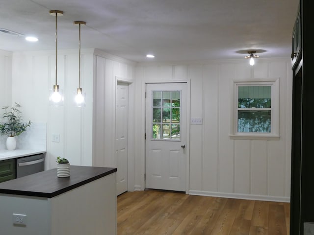 205 W 5th St, Parsons, TN 38363 - doorway to outside with light wood-type flooring, a decorative wall, and recessed lighting
