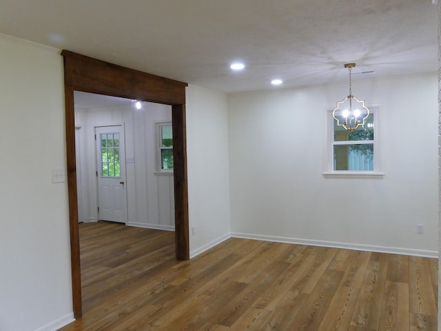 205 W 5th St, Parsons, TN 38363 - spare room featuring a chandelier, wood finished floors, baseboards, and recessed lighting