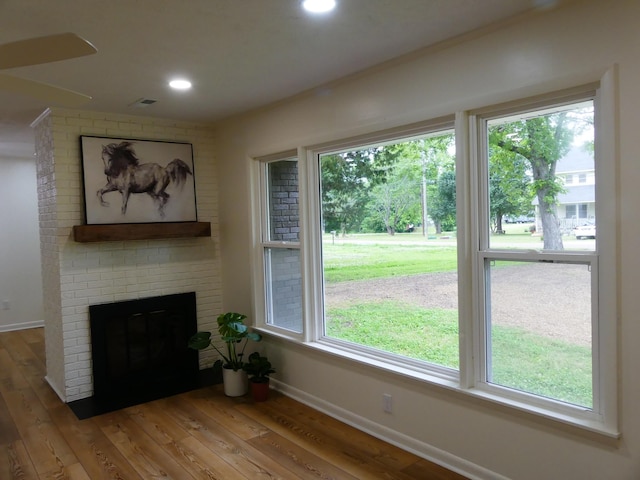 205 W 5th St, Parsons, TN 38363 - unfurnished living room with wood finished floors, healthy amount of natural light, baseboards, recessed lighting, and a fireplace