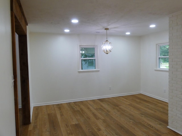 205 W 5th St, Parsons, TN 38363 - empty room with recessed lighting, wood finished floors, baseboards, and a chandelier