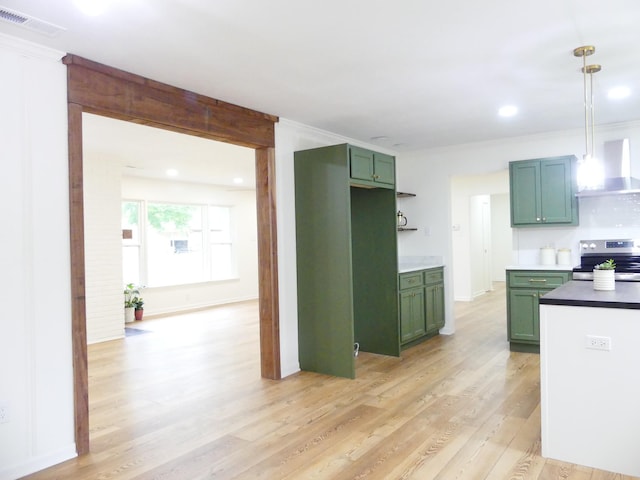 205 W 5th St, Parsons, TN 38363 - kitchen featuring electric range, green cabinetry, wall chimney exhaust hood, light wood finished floors, and pendant lighting