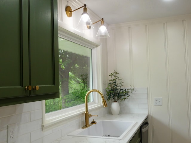 205 W 5th St, Parsons, TN 38363 - kitchen with green cabinetry, a sink, a decorative wall, and light stone countertops