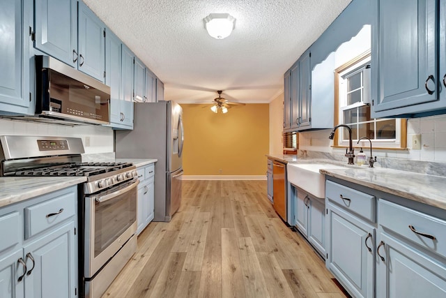 33 Edgewood Rd, Alexandria, TN 37012 - kitchen with stainless steel appliances, a sink, a ceiling fan, light wood-style flooring, and a textured ceiling