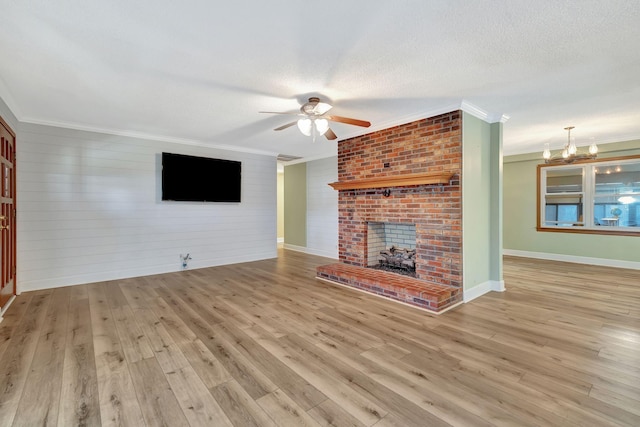 33 Edgewood Rd, Alexandria, TN 37012 - unfurnished living room featuring crown molding, a ceiling fan, wood finished floors, a chandelier, and a fireplace