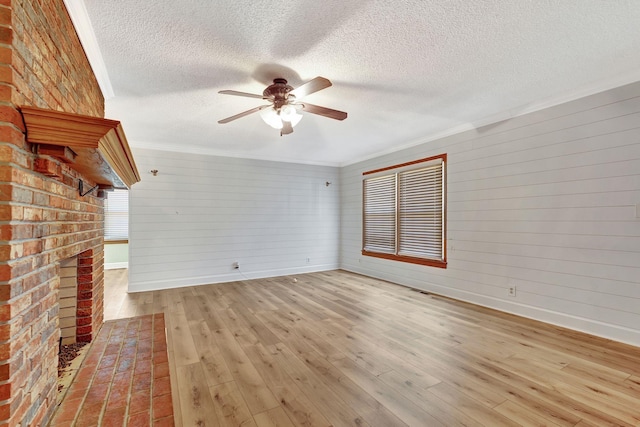 33 Edgewood Rd, Alexandria, TN 37012 - unfurnished living room with a textured ceiling, ceiling fan, wood-type flooring, baseboards, and crown molding