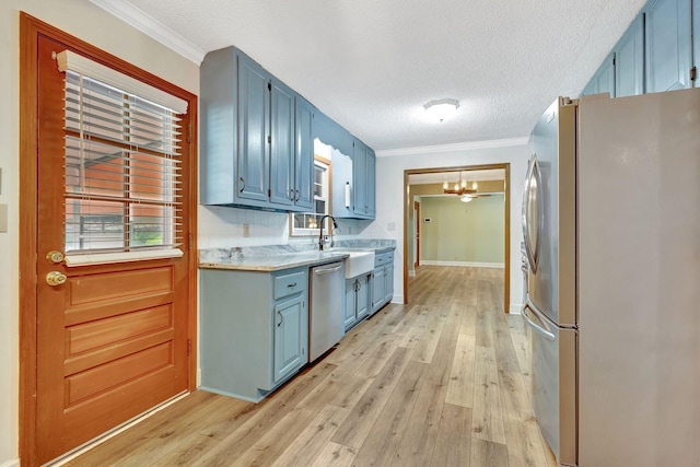 33 Edgewood Rd, Alexandria, TN 37012 - kitchen featuring appliances with stainless steel finishes, blue cabinetry, a chandelier, light countertops, and light wood-style floors