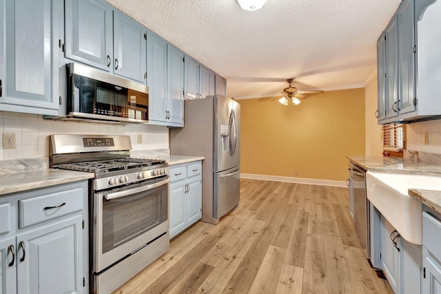 33 Edgewood Rd, Alexandria, TN 37012 - kitchen with stainless steel appliances, a ceiling fan, decorative backsplash, ornamental molding, and light wood finished floors