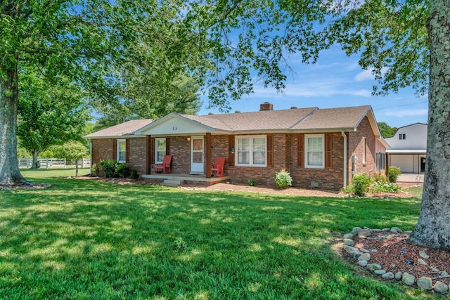 33 Edgewood Rd, Alexandria, TN 37012 - ranch-style house with a chimney, covered porch, brick siding, roof with shingles, and a garage