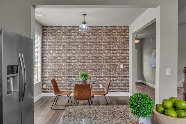 1010 Keeneland Dr, Spring Hill, TN 37174 - dining room with brick wall, baseboards, wood finished floors, and healthy amount of natural light