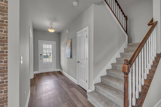 1010 Keeneland Dr, Spring Hill, TN 37174 - foyer featuring dark wood-type flooring, stairway, baseboards, and brick wall