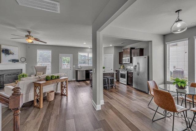1010 Keeneland Dr, Spring Hill, TN 37174 - living room featuring dark wood-style flooring, a glass covered fireplace, ceiling fan, and recessed lighting