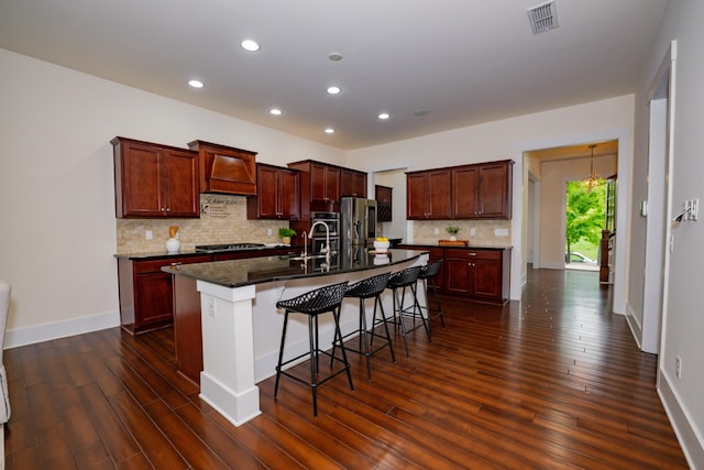 1820 Lanceford Ct, Franklin, TN 37067 - kitchen with recessed lighting, stainless steel appliances, dark wood finished floors, a breakfast bar area, and custom range hood